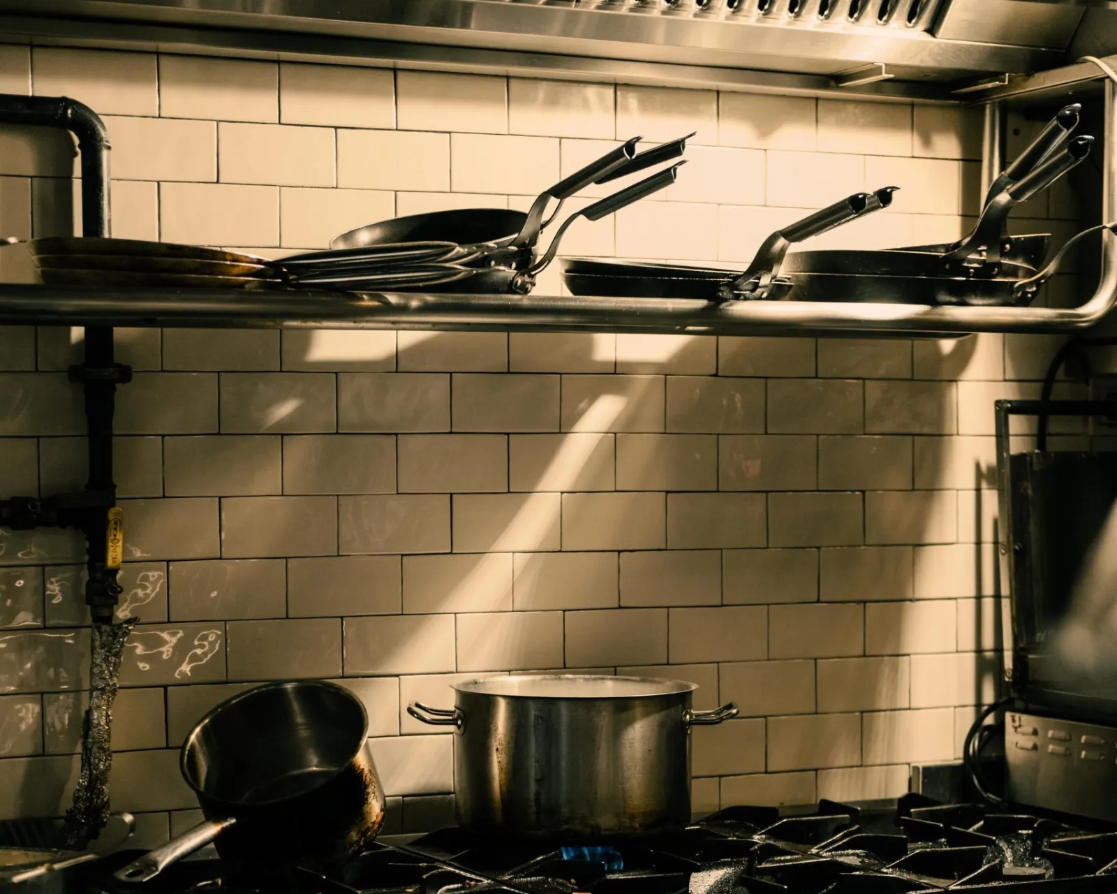 Commercial appliance repair: commercial kitchen range with stock pots on the line